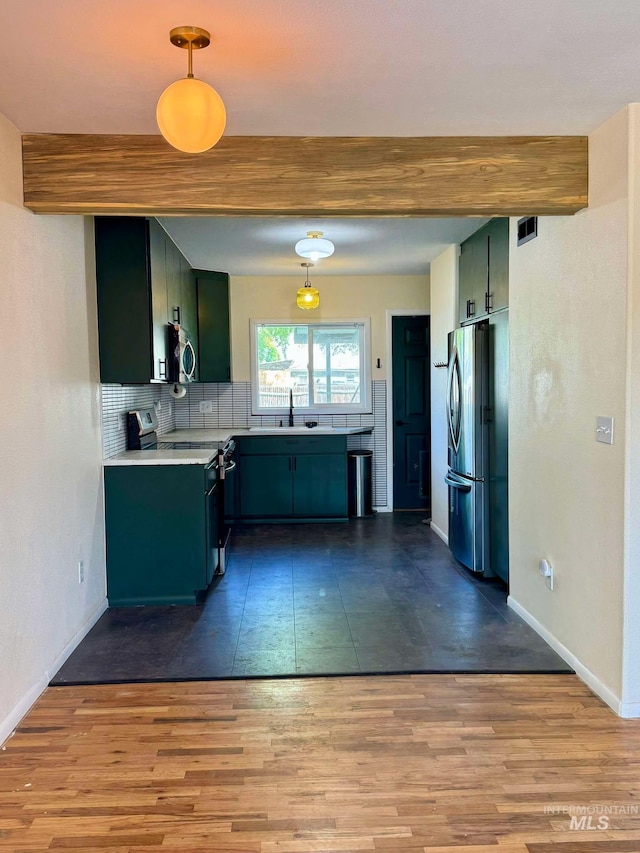 23212NDAVEN 2nd Ave N, Lewiston, ID 83501 - kitchen with light countertops, appliances with stainless steel finishes, tasteful backsplash, and wood finished floors