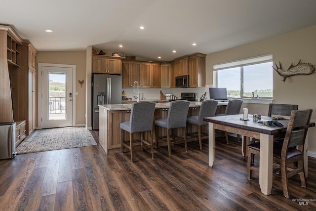 13005 Lake Shore Dr, Nampa, ID 83686 - kitchen featuring dark wood-type flooring, lofted ceiling, a sink, and appliances with stainless steel finishes