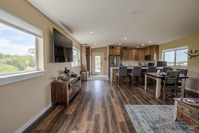 13005 Lake Shore Dr, Nampa, ID 83686 - living room with dark wood-style flooring, baseboards, and lofted ceiling