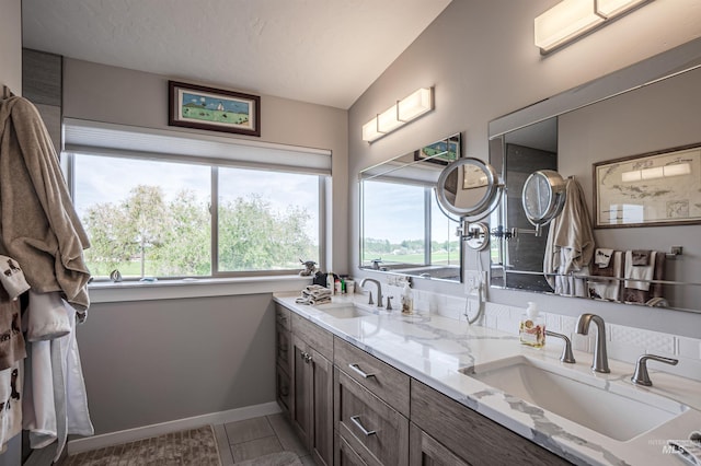 13005 Lake Shore Dr, Nampa, ID 83686 - full bath featuring a sink, baseboards, double vanity, and tile patterned flooring