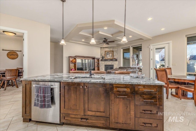 4595 N Tirso Ave, Meridian, ID 83646 - kitchen featuring light stone countertops, a sink, a fireplace, a ceiling fan, and coffered ceiling