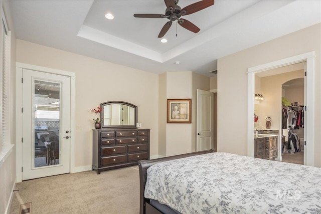4595 N Tirso Ave, Meridian, ID 83646 - bedroom with arched walkways, a raised ceiling, connected bathroom, light carpet, and recessed lighting