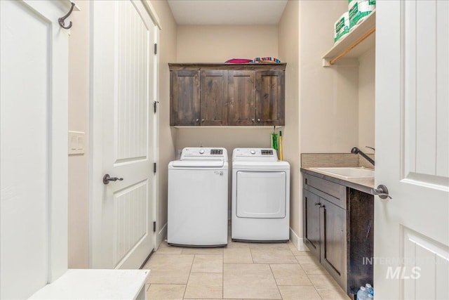 4595 N Tirso Ave, Meridian, ID 83646 - laundry room with cabinet space, independent washer and dryer, a sink, baseboards, and light tile patterned floors