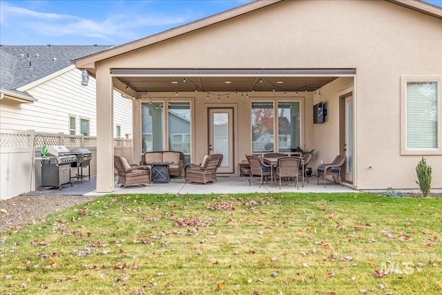 4595 N Tirso Ave, Meridian, ID 83646 - back of house featuring fence, stucco siding, a yard, and a patio area