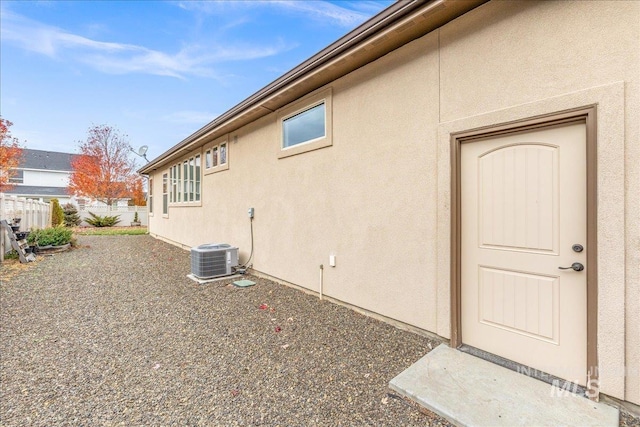 4595 N Tirso Ave, Meridian, ID 83646 - view of side of property with central air condition unit, fence, and stucco siding