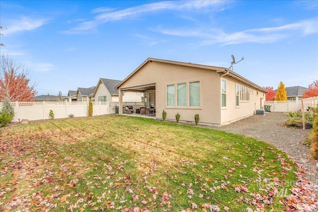 4595 N Tirso Ave, Meridian, ID 83646 - rear view of property with a yard, a fenced backyard, a patio area, and stucco siding