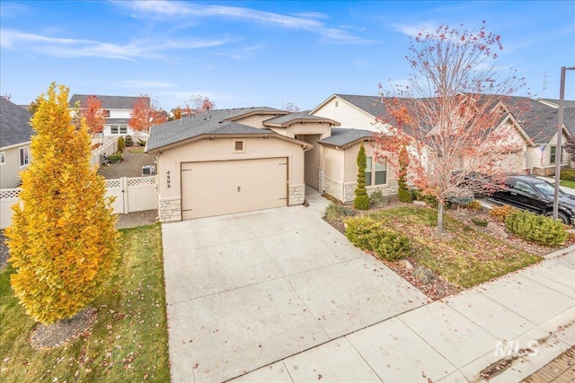 4595 N Tirso Ave, Meridian, ID 83646 - traditional-style house with fence, stone siding, stucco siding, concrete driveway, and an attached garage