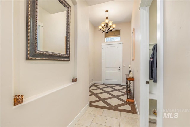 4595 N Tirso Ave, Meridian, ID 83646 - doorway featuring light tile patterned floors, baseboards, and a notable chandelier