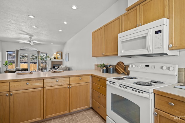 kitchen with ceiling fan, white appliances, kitchen peninsula, and a textured ceiling