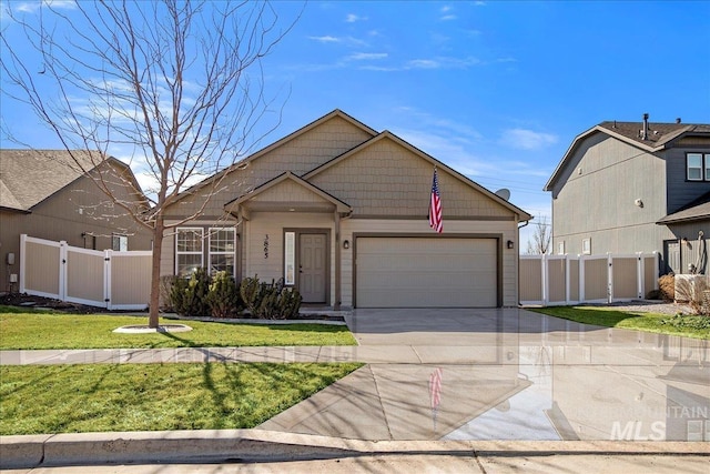 view of front facade featuring a gate, fence, driveway, an attached garage, and a front lawn