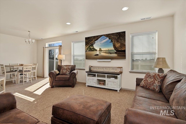 living area with recessed lighting, visible vents, carpet floors, and a chandelier