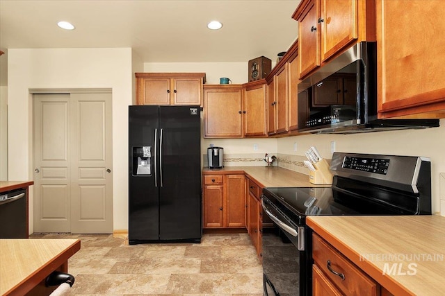 kitchen featuring light countertops, dishwashing machine, stainless steel range with electric cooktop, brown cabinetry, and black fridge with ice dispenser