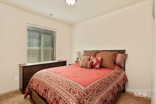 bedroom with visible vents, baseboards, and carpet flooring