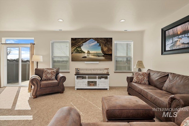 carpeted living area featuring recessed lighting and visible vents