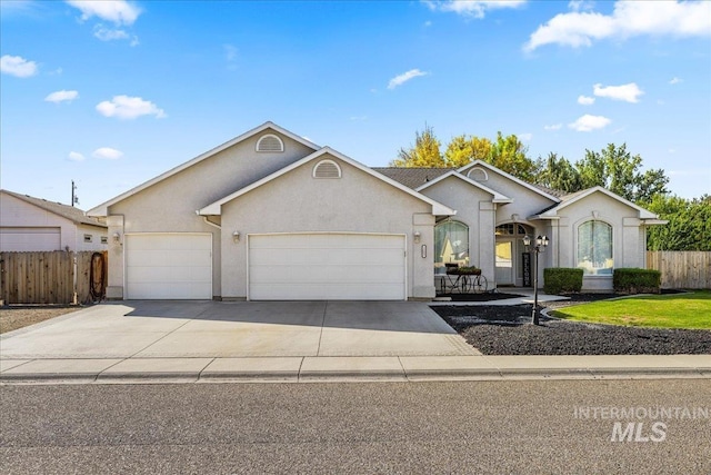 ranch-style house with an attached garage, concrete driveway, and stucco siding