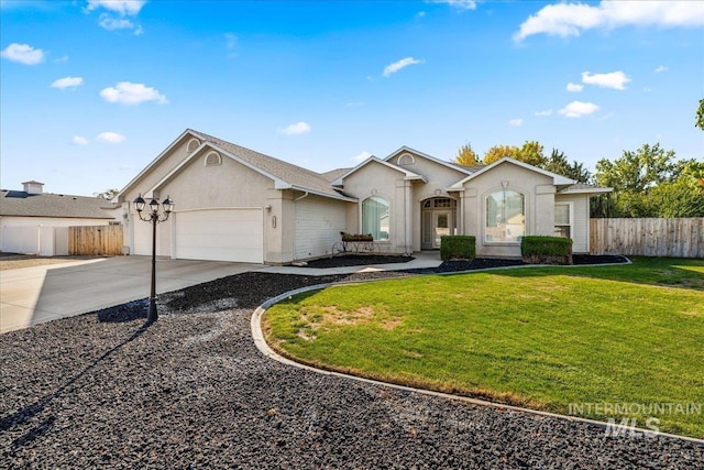 single story home featuring a garage, fence, driveway, stucco siding, and a front yard