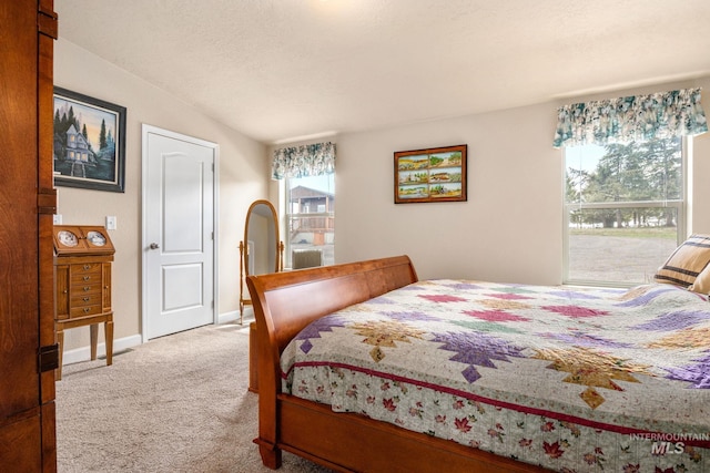 carpeted bedroom featuring baseboards and a textured ceiling