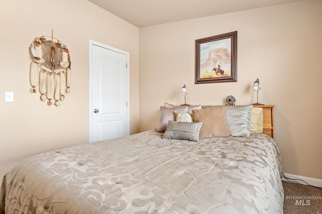 bedroom with carpet and baseboards