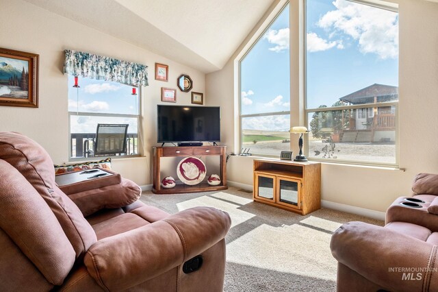 carpeted living room featuring vaulted ceiling and baseboards