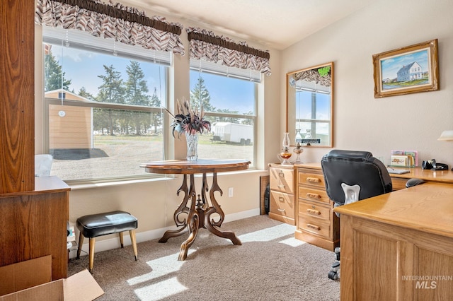 office area featuring baseboards, carpet floors, and vaulted ceiling