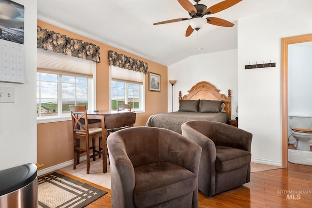 bedroom featuring ceiling fan, baseboards, lofted ceiling, and wood finished floors