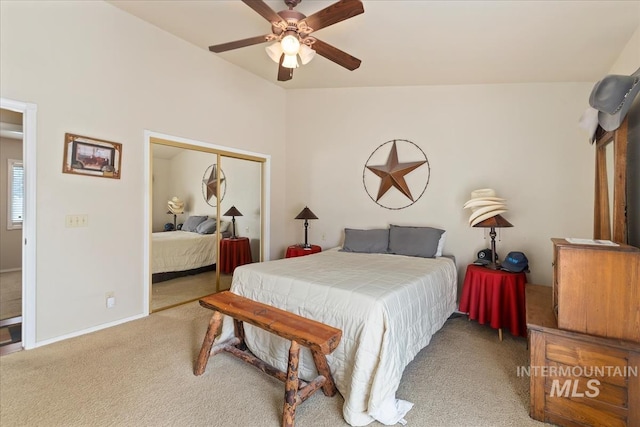bedroom featuring a ceiling fan, a closet, carpet floors, baseboards, and lofted ceiling