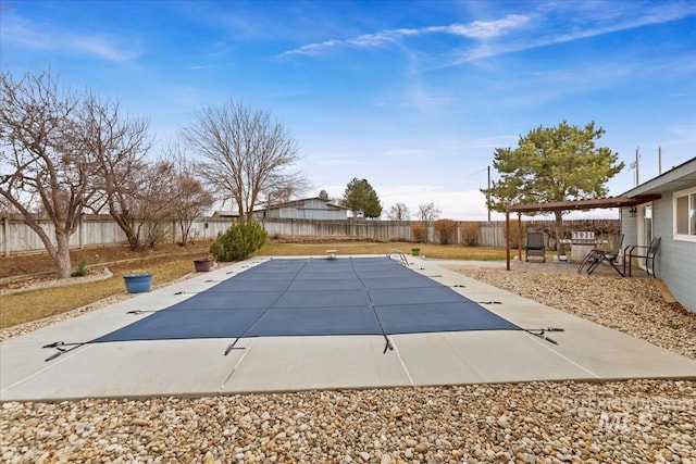 view of swimming pool with a fenced backyard and a patio area