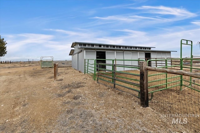 view of horse barn featuring a rural view