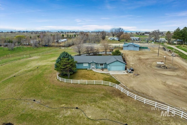 birds eye view of property with a rural view