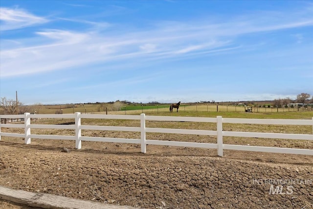 view of yard featuring a rural view and fence