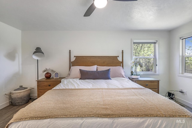 bedroom featuring baseboards, a ceiling fan, and wood finished floors