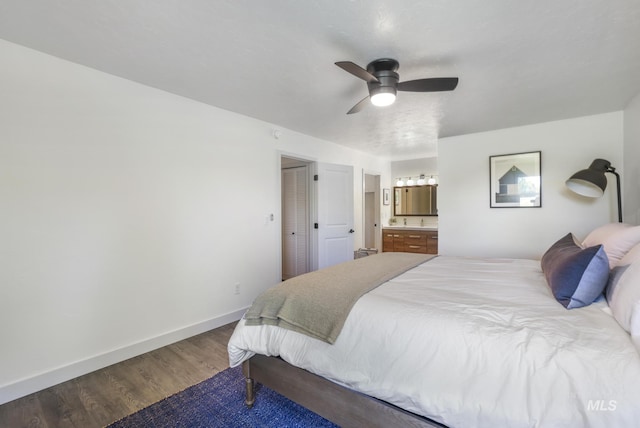 bedroom with baseboards, connected bathroom, a ceiling fan, and wood finished floors