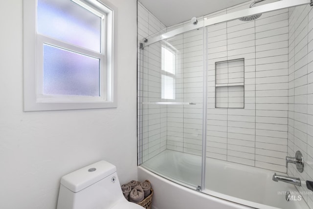 bathroom featuring toilet and enclosed tub / shower combo