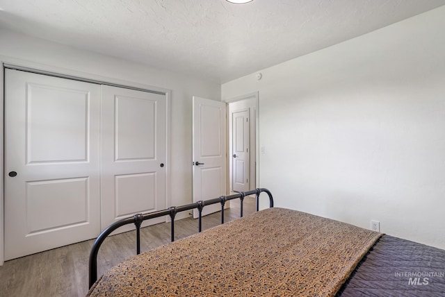 bedroom featuring a closet and light wood-style flooring