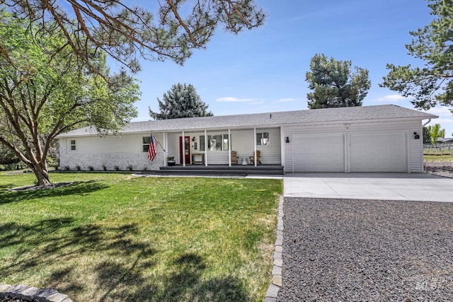 ranch-style home featuring a front yard, a porch, driveway, and a garage