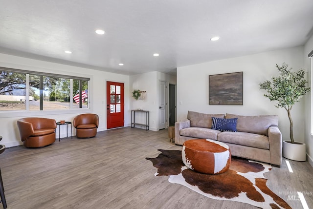 living area with wood finished floors, baseboards, and recessed lighting
