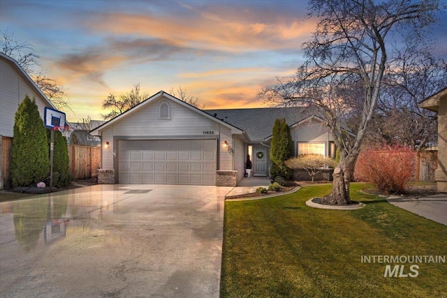 ranch-style house featuring fence, a yard, concrete driveway, a garage, and brick siding