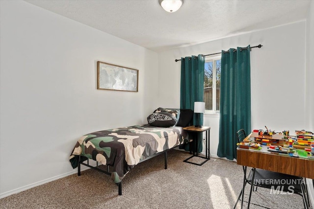 carpeted bedroom featuring a textured ceiling and baseboards