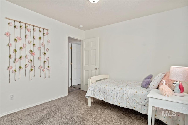 bedroom featuring carpet flooring, a textured ceiling, and baseboards