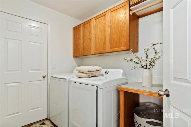 laundry area with cabinet space and independent washer and dryer