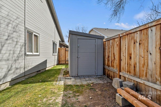 view of yard with a fenced backyard, a storage shed, and an outdoor structure