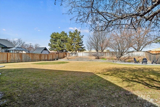 view of yard with a fenced backyard