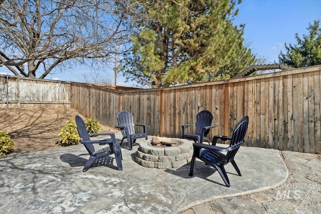 view of patio with an outdoor fire pit and a fenced backyard