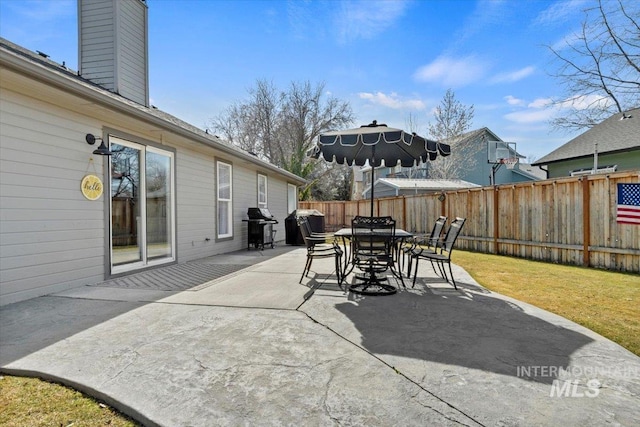 view of patio / terrace featuring outdoor dining area, fence, and grilling area