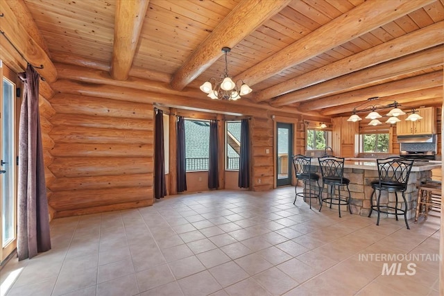 dining space with beam ceiling, a chandelier, wooden ceiling, and light tile patterned floors
