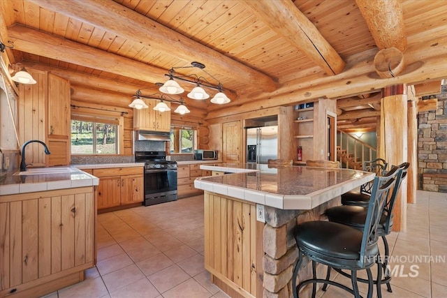 kitchen featuring tile countertops, appliances with stainless steel finishes, a sink, wooden ceiling, and light tile patterned flooring