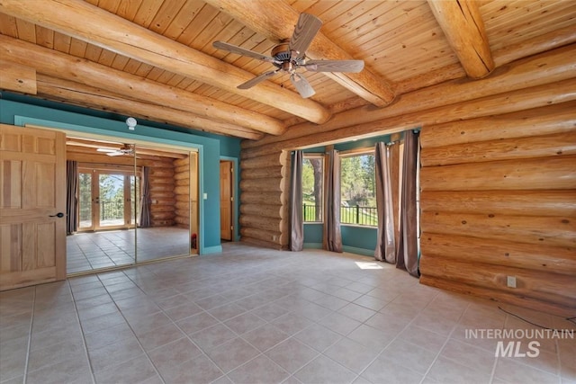 spare room with tile patterned flooring, wood ceiling, and plenty of natural light