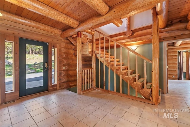 tiled foyer entrance with wood ceiling, beam ceiling, visible vents, and log walls