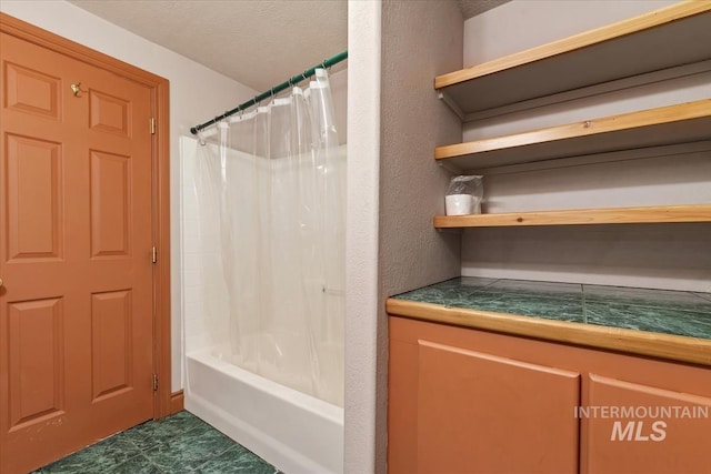 bathroom with shower / bathtub combination with curtain