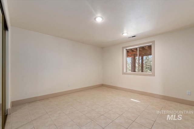 empty room featuring baseboards, recessed lighting, light tile patterned flooring, and visible vents
